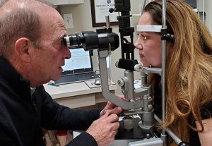 Dr. Polakoff giving an eye exam